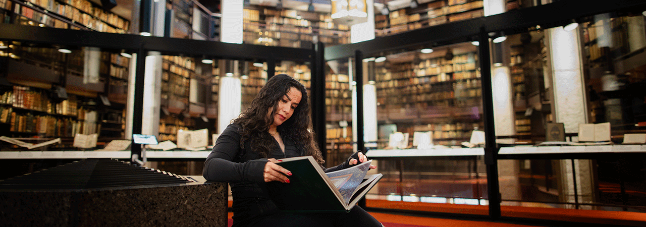 Tayebeh Asadimofarah Reading a book in the  Thomas Fisher Rare Book Library